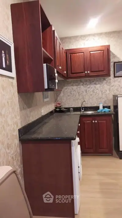 Charming kitchen with wooden cabinets and modern appliances, perfect for culinary enthusiasts.