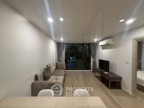 Spacious modern living room with sleek design and large window view