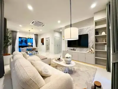 Luxurious modern living room with elegant decor and open dining area, perfect for stylish living.