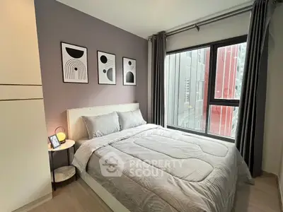 Modern bedroom with stylish decor and large window in urban apartment