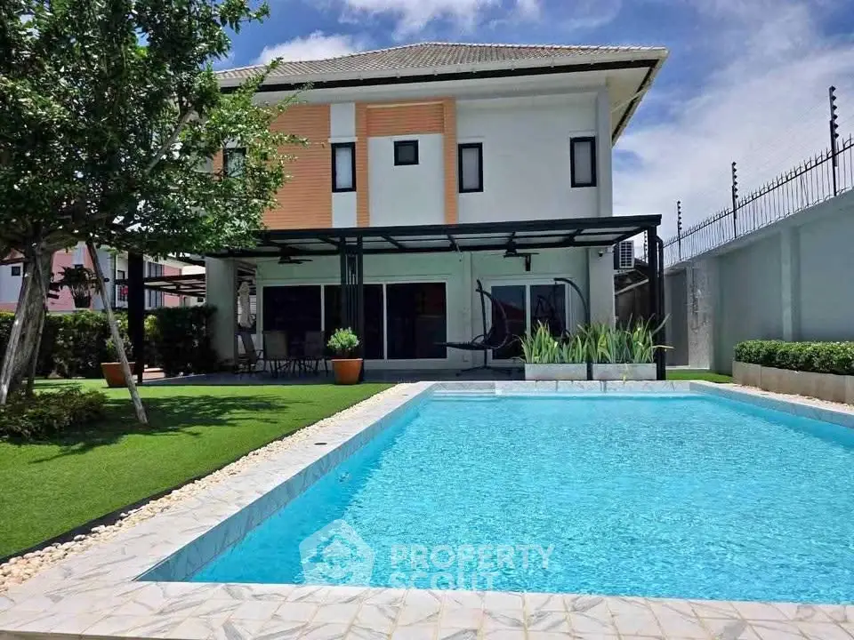 Luxurious modern home with a stunning private pool and lush garden, perfect for relaxation and entertainment.