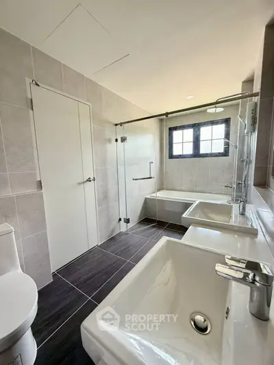 Modern bathroom with sleek fixtures and glass shower enclosure