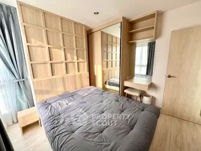 Modern bedroom with stylish wooden paneling and cozy bedding in a bright apartment.