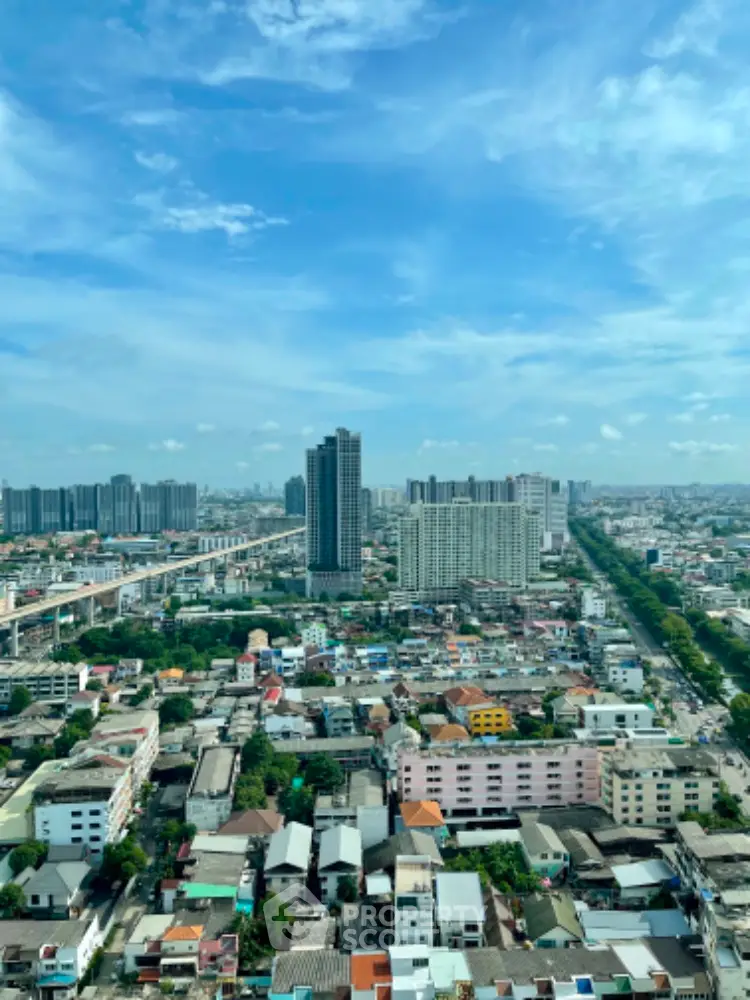 Stunning cityscape view showcasing urban skyline and residential buildings under a clear blue sky.