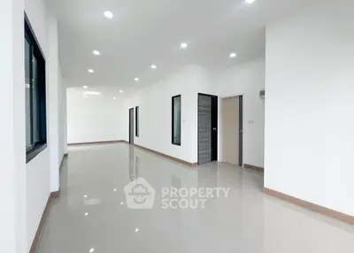 Spacious modern interior with sleek tile flooring and ample natural light, perfect for versatile living arrangements.