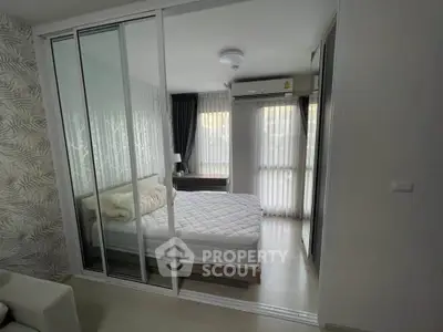 Modern bedroom with sliding glass doors and natural light