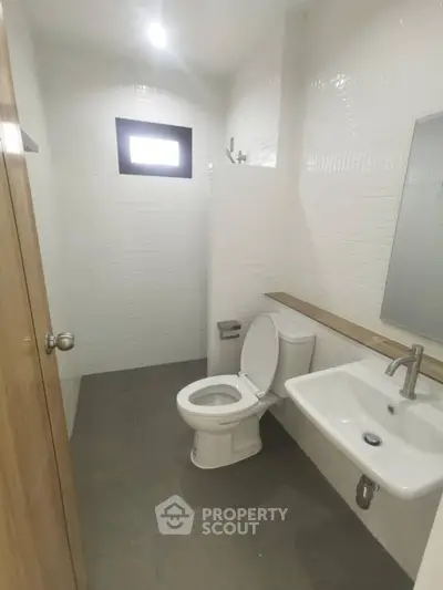 Modern minimalist bathroom with white tiles and sleek fixtures