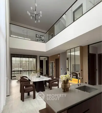 Luxurious modern living room with high ceilings and elegant dining area