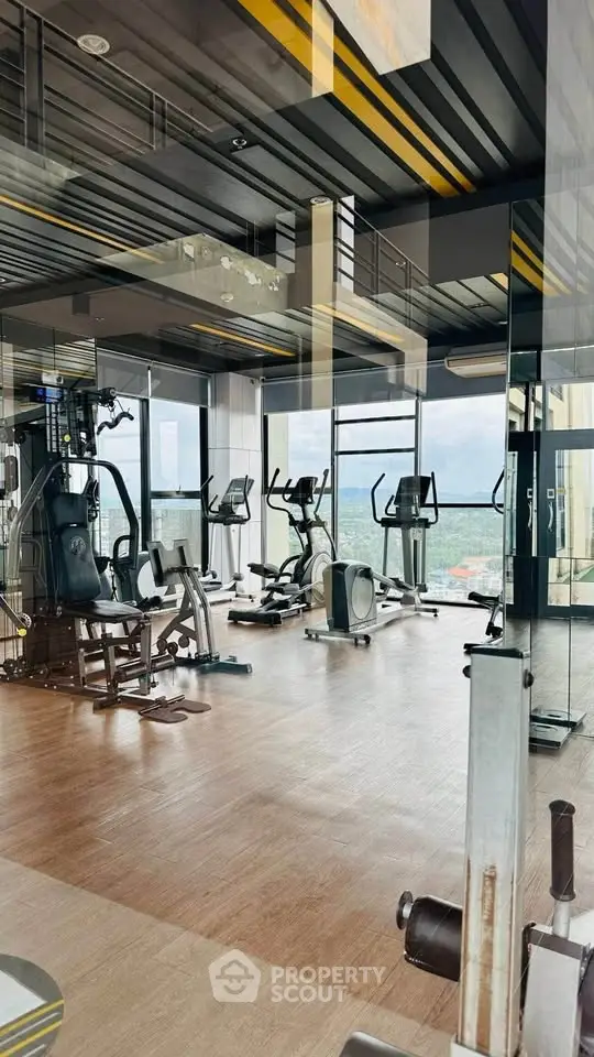 Modern gym with panoramic city views and state-of-the-art fitness equipment.
