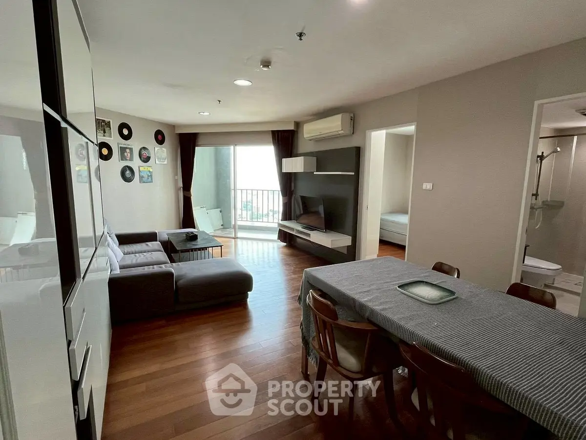 Spacious living room with modern decor and balcony access in a stylish apartment.