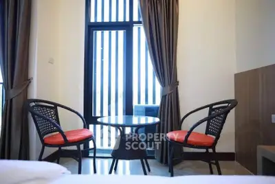 Cozy seating area with modern chairs and table by a window in a stylish room.