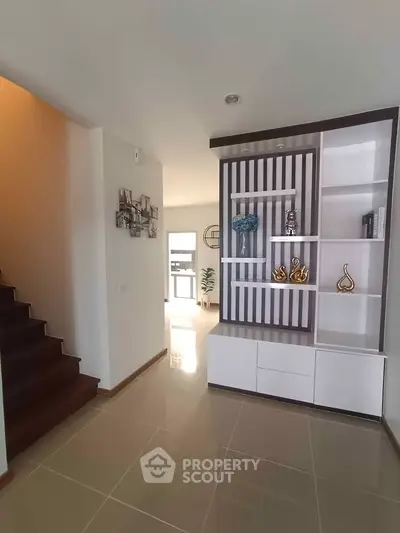 Modern interior with stylish shelving and staircase in a bright home