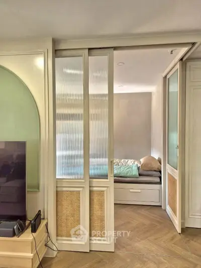Stylish bedroom with sliding doors and cozy bed in modern apartment