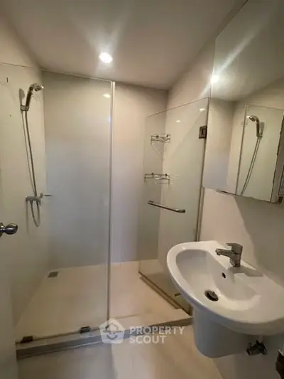 Modern bathroom with glass shower enclosure and sleek sink design