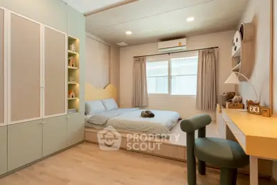 Charming bedroom with modern decor, built-in storage, and natural light.