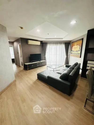 Spacious living room with modern decor and large windows for natural light.
