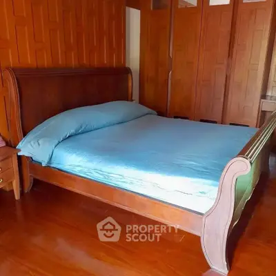 Elegant wooden bedroom with stylish bed and cozy atmosphere