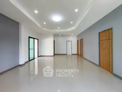 Spacious modern living room with sleek tile flooring and recessed lighting