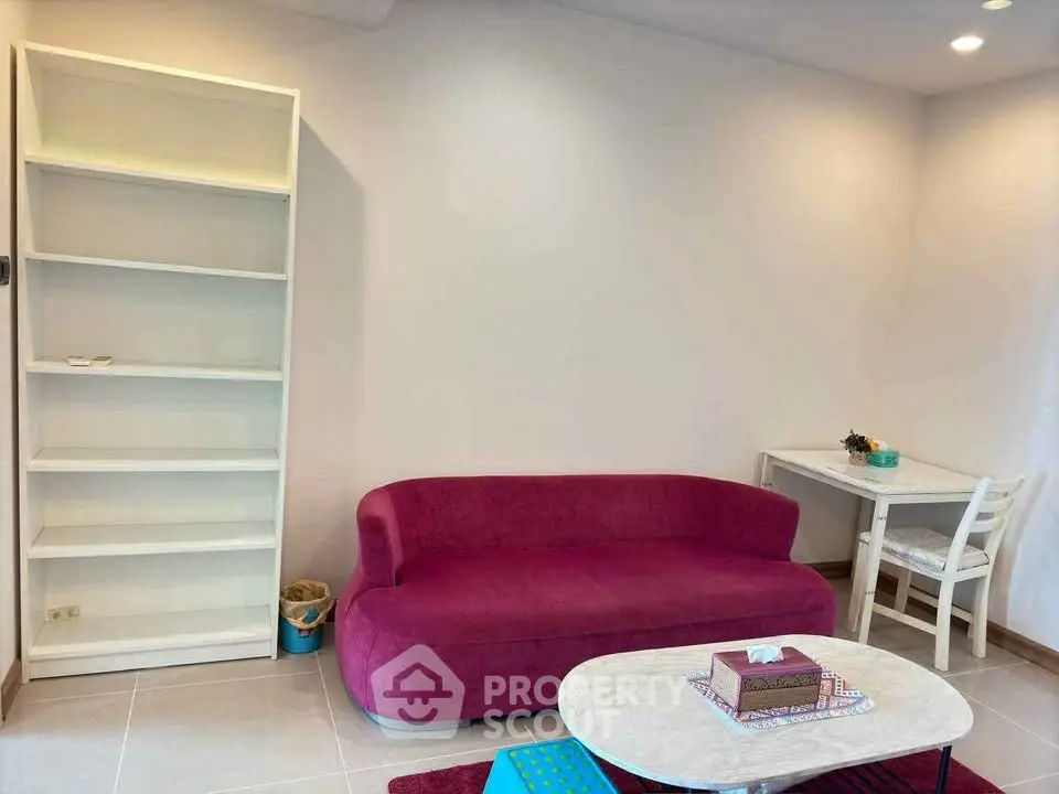 Chic living room with vibrant pink sofa and modern decor