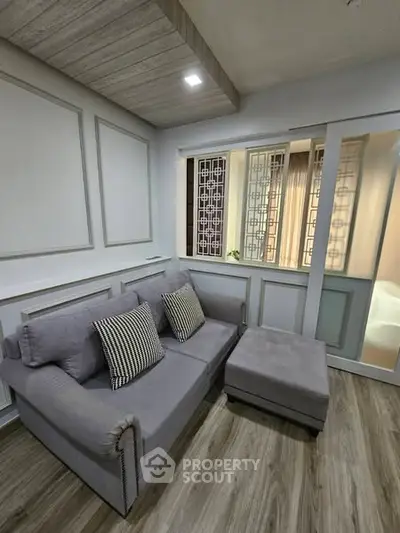 Chic modern living room with stylish grey sofa and elegant decor