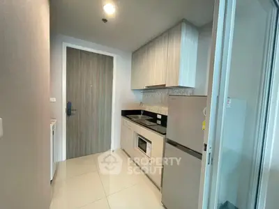 Modern kitchen with sleek cabinetry and stainless steel appliances in a compact layout.