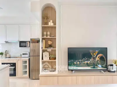 Modern living room with stylish shelving and sleek kitchen appliances, perfect for contemporary living.