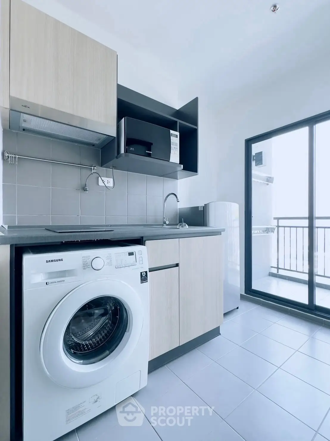 Modern kitchen with washing machine and balcony access