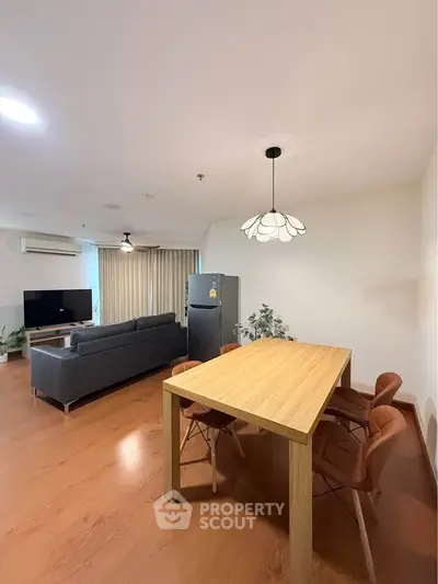Spacious modern living room with elegant dining area and stylish furniture, perfect for entertaining guests.