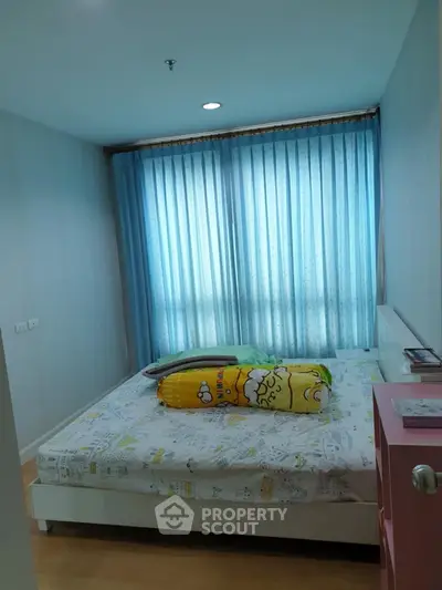 Cozy bedroom with large window and blue curtains in modern apartment