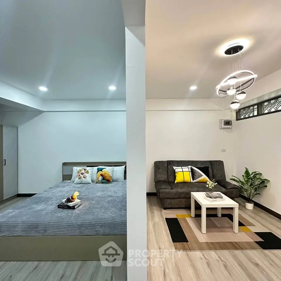 Modern studio apartment with cozy living area and stylish bedroom decor.