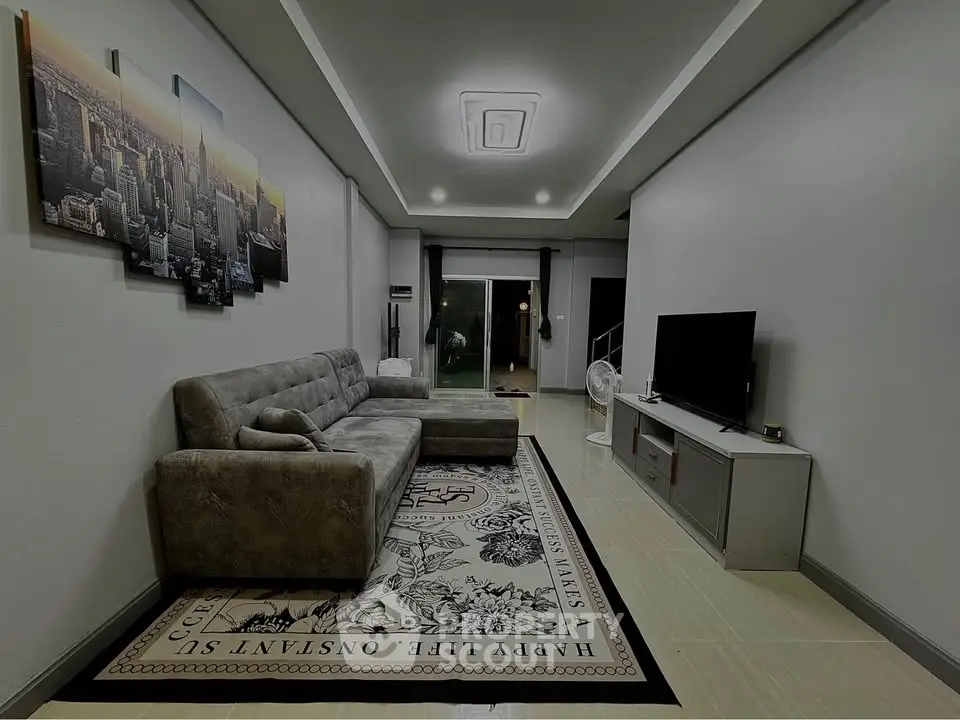 Spacious modern living room with stylish decor and comfortable seating, perfect for relaxation and entertainment.