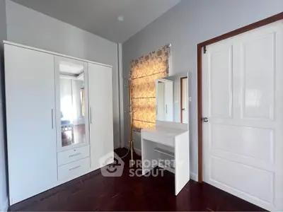 Spacious bedroom with elegant wardrobe and vanity set