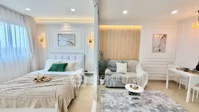 Luxurious modern studio apartment with elegant bedroom and cozy living area, featuring stylish decor and ample natural light.