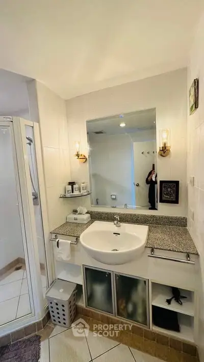Modern bathroom with sleek sink and glass shower enclosure