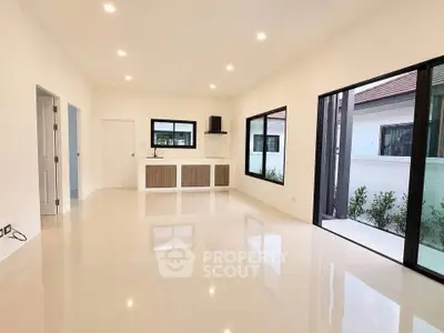 Spacious modern living room with large windows and sleek flooring