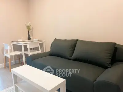 Cozy living room with modern sofa and dining table, perfect for urban living.