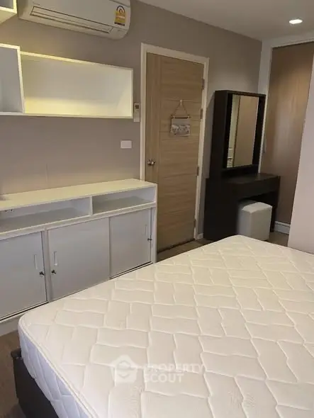 Modern bedroom with built-in storage and air conditioning, perfect for comfort and convenience.