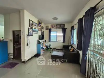 Spacious living room with modern decor and large windows for natural light.