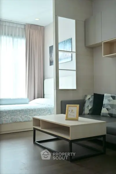 Modern living room with stylish decor and natural light in a cozy apartment.
