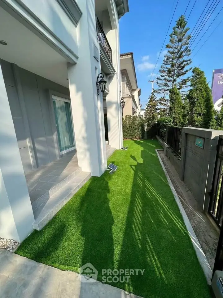 Charming residential exterior with lush green lawn and modern architecture, perfect for family living.