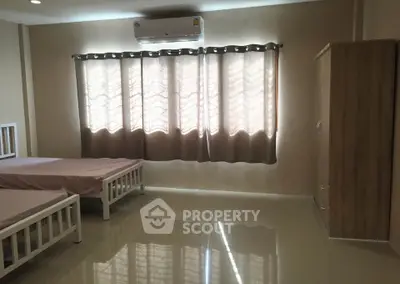 Spacious bedroom with twin beds and ample natural light
