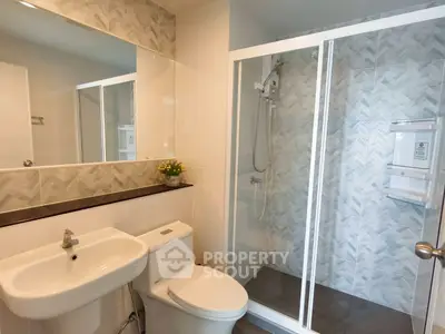 Modern bathroom with glass shower and stylish tile design