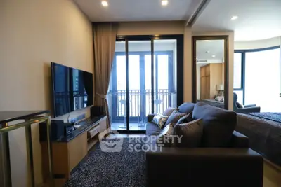 Modern living room with balcony access and stylish decor in urban apartment.