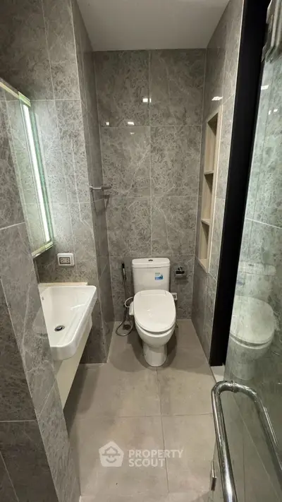 Modern bathroom with sleek marble tiles and contemporary fixtures
