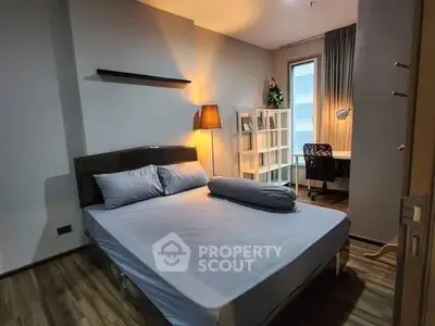 Cozy bedroom with modern decor and study area, perfect for urban living.