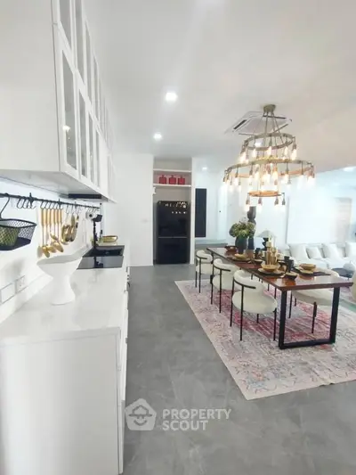 Luxurious open-plan kitchen and dining area with elegant decor and modern lighting