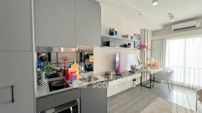 Modern open-plan kitchen and living area with sleek design and natural light