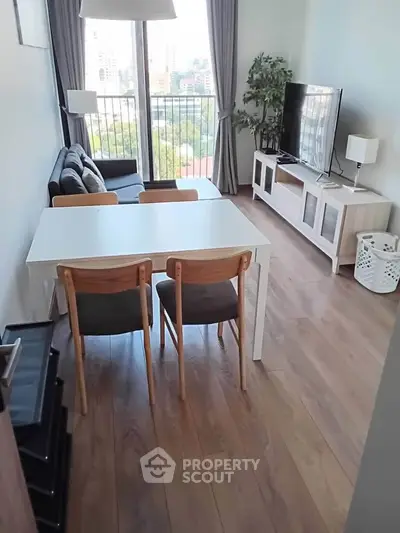 Modern living room with city view, stylish furniture, and natural light.