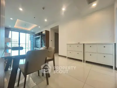 Spacious modern living room with elegant dining area and large windows offering natural light.