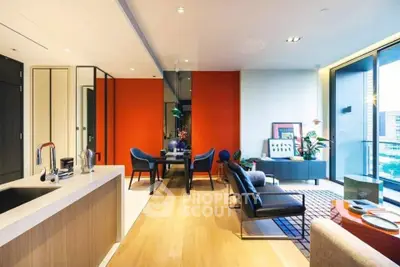 Modern open-plan living room with vibrant orange accent wall and city view balcony.